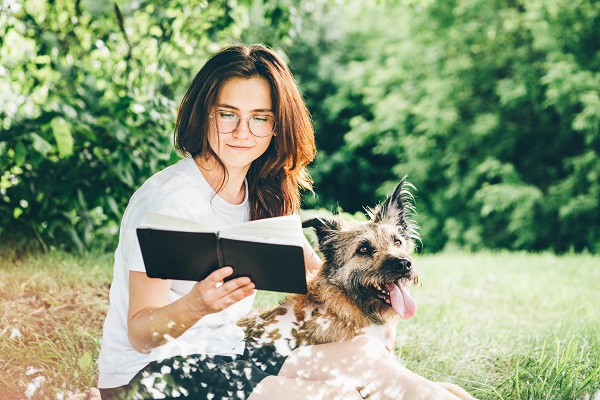 girl-in-glasses-and-t-shirt-reads-book-sitting-on-2021-08-28-12-30-54-utc